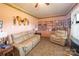 A comfortable living room with pink walls, a large leather couch, an accent chair, and built in shelves at 100 S Rudisill Ave, Cherryville, NC 28021