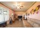 A cozy living room featuring light pink walls, a unique butterfly wall hanging, and comfortable seating area at 100 S Rudisill Ave, Cherryville, NC 28021
