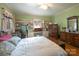 A well-lit main bedroom featuring built-in shelving and a calming green color scheme at 100 S Rudisill Ave, Cherryville, NC 28021