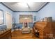 A quiet office with light blue walls, vintage wooden desk, plush armchair, and natural lighting at 100 S Rudisill Ave, Cherryville, NC 28021