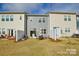 Townhome backyards with patios, furniture, and green lawns at 1028 Grays Mill Rd, Charlotte, NC 28215