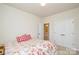 Neutral bedroom with large double door closet and a view into the Primary bath at 1028 Grays Mill Rd, Charlotte, NC 28215