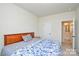 Cozy bedroom with a wooden headboard bed, neutral walls, and a view of an open closet at 1028 Grays Mill Rd, Charlotte, NC 28215