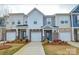 Charming townhome showcasing brick and siding exteriors, garages, and well-maintained landscaping at 1028 Grays Mill Rd, Charlotte, NC 28215