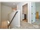 Upstairs hallway leading to a laundry room with side-by-side washer and dryer at 1028 Grays Mill Rd, Charlotte, NC 28215
