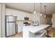 Stylish kitchen featuring white cabinets, stainless steel appliances, and a modern island with seating at 1028 Grays Mill Rd, Charlotte, NC 28215