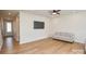 Spacious living room with wood floors, recessed lighting, and neutral decor for a comfortable living space at 1028 Grays Mill Rd, Charlotte, NC 28215
