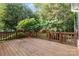 Wooden deck with wood railing and trees in the background at 10927 Thornhill Club Dr, Charlotte, NC 28277