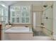 Bright bathroom with soaking tub and stand up shower at 10927 Thornhill Club Dr, Charlotte, NC 28277