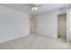 Minimalist bedroom with neutral walls, carpet flooring, a ceiling fan, and a closet, providing a blank canvas at 10927 Thornhill Club Dr, Charlotte, NC 28277