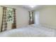 Bright bedroom with window views and neutral carpet at 10927 Thornhill Club Dr, Charlotte, NC 28277