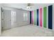 Bright bedroom with colorful stripe accent wall and neutral carpet at 10927 Thornhill Club Dr, Charlotte, NC 28277