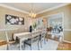 Formal dining room showcases a modern chandelier, stylish decor, and a smooth transition to adjacent living spaces at 10927 Thornhill Club Dr, Charlotte, NC 28277