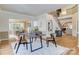 Open-concept dining area with an elegant dining table and clear view of a staircase leading to the 2nd story at 10927 Thornhill Club Dr, Charlotte, NC 28277