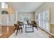 Open-concept dining area with hardwood floors, a bay window, and adjacent rooms for easy entertaining at 10927 Thornhill Club Dr, Charlotte, NC 28277
