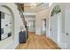Grand foyer with hardwood floors, staircase, chandelier, and plenty of natural light at 10927 Thornhill Club Dr, Charlotte, NC 28277