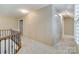 Upstairs hallway landing with carpet and white closet doors at 10927 Thornhill Club Dr, Charlotte, NC 28277