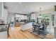Bright kitchen features stainless steel appliances, granite countertops, and an adjacent dining area with large windows at 10927 Thornhill Club Dr, Charlotte, NC 28277