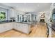 Open kitchen with stainless steel appliances, granite countertops, leading to a living room with fireplace at 10927 Thornhill Club Dr, Charlotte, NC 28277