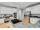 Open kitchen boasts stainless steel appliances, custom cabinetry, and granite countertops with a cooktop at 10927 Thornhill Club Dr, Charlotte, NC 28277
