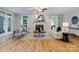 Bright and airy living room with hardwood floors, fireplace, large windows, and comfortable seating at 10927 Thornhill Club Dr, Charlotte, NC 28277