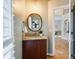 Cozy powder room featuring a wooden vanity with granite top, round mirror, and decorative wall art at 10927 Thornhill Club Dr, Charlotte, NC 28277