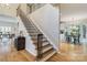 Elegant staircase with hardwood steps and ornate railings, connecting to the home's open floor plan at 10927 Thornhill Club Dr, Charlotte, NC 28277