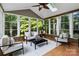 Bright sunroom with vaulted ceilings, skylight and views of the surrounding trees at 10927 Thornhill Club Dr, Charlotte, NC 28277