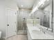 A bright bathroom features double vanity sinks, modern lighting, and a glass-enclosed shower at 116 Eve Ash Ln, Mooresville, NC 28115