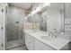 A well-lit bathroom features double vanity sinks, modern lighting, and a glass-enclosed shower at 116 Eve Ash Ln, Mooresville, NC 28115