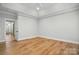 A bright and airy bedroom features hardwood floors, tray ceiling, and neutral paint at 116 Eve Ash Ln, Mooresville, NC 28115
