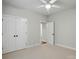 Large bedroom with a ceiling fan, double closets, and an open door to another room at 116 Eve Ash Ln, Mooresville, NC 28115
