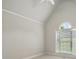Bright bedroom featuring a high vaulted ceiling and a large window bringing in natural light at 116 Eve Ash Ln, Mooresville, NC 28115