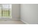 This bedroom has neutral walls, carpet floors and bright natural light from the large window at 116 Eve Ash Ln, Mooresville, NC 28115
