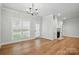 Bright dining room with hardwood floors, fireplace, and large windows, creating a warm and inviting atmosphere at 116 Eve Ash Ln, Mooresville, NC 28115