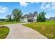 Long driveway leads to a home with a two-car garage, surrounded by lush greenery and a well-maintained lawn at 116 Eve Ash Ln, Mooresville, NC 28115