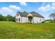 Charming exterior view of a two-story home with white brick and siding, complemented by a lush green lawn at 116 Eve Ash Ln, Mooresville, NC 28115