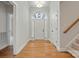 Bright foyer featuring hardwood floors, a staircase, and an arched window above the front door at 116 Eve Ash Ln, Mooresville, NC 28115