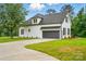 This home features a spacious two-car garage and driveway, set against the backdrop of a well-manicured lawn at 116 Eve Ash Ln, Mooresville, NC 28115