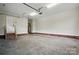 Spacious two-car garage features a water heater, automatic door, and brick trim along the walls at 116 Eve Ash Ln, Mooresville, NC 28115