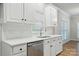Modern kitchen design with stainless steel appliances, white subway tile, and white countertops at 116 Eve Ash Ln, Mooresville, NC 28115