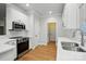 Contemporary kitchen with stainless steel appliances, white countertops, and ample cabinet storage at 116 Eve Ash Ln, Mooresville, NC 28115