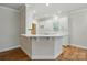 Clean, white kitchen featuring sleek quartz countertops, an island, and ample cabinet space at 116 Eve Ash Ln, Mooresville, NC 28115