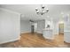 Expansive living area seamlessly integrates with the kitchen, featuring hardwood floors and modern lighting fixtures at 116 Eve Ash Ln, Mooresville, NC 28115