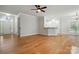 Open-concept living room with hardwood floors and seamless transitions to the foyer and kitchen at 116 Eve Ash Ln, Mooresville, NC 28115