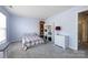 Neutral bedroom featuring a cozy bed, bookshelves, and a dresser with a decorative lamp at 12328 Jessica Pl, Charlotte, NC 28269