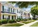 Well-maintained townhouse with green shutters, manicured landscaping, and a charming covered entrance in a neighborhood setting at 12328 Jessica Pl, Charlotte, NC 28269