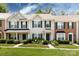 Charming townhouse with a well-manicured lawn, green door, shutters, and inviting curb appeal at 12328 Jessica Pl, Charlotte, NC 28269