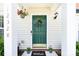 Inviting front entryway with a green door, decorative wreath, and a 'Welcome' mat adding a cozy touch at 12328 Jessica Pl, Charlotte, NC 28269