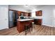 Well-lit kitchen features stainless steel appliances, center island, and warm wood cabinets at 12328 Jessica Pl, Charlotte, NC 28269